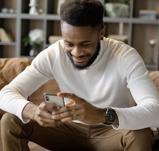 man texting on couch